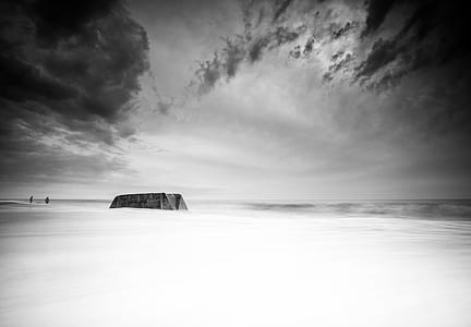 grayscale photo of platform under cloudy sky thumbnail