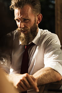 man wearing white dress shirt sitting down thumbnail