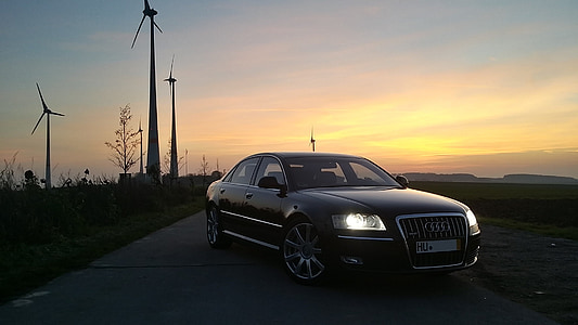 black Audi sedan parked near windmills thumbnail