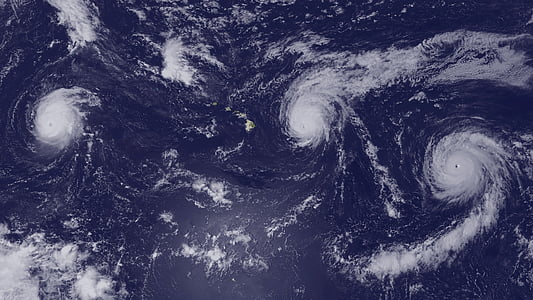 space photography of three typhoons on earth's body of water thumbnail