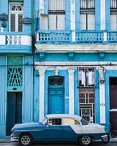 Classic Blue and White Sedan Near Building thumbnail