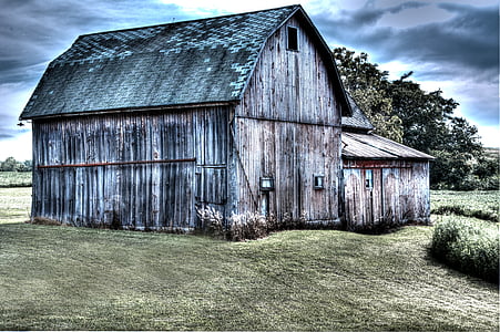 gray wooden shed under cloudy sky thumbnail