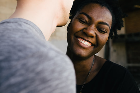 woman in black top smiling near person in gray top thumbnail