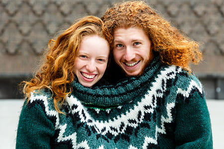 two smiling person sharing white and gray knit textile thumbnail