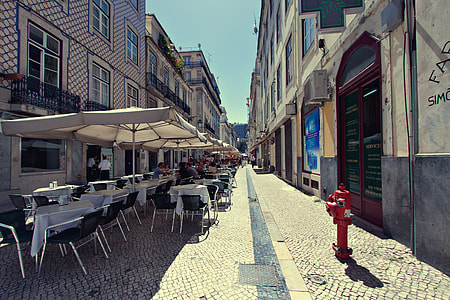 People site outside a restaurant in Lisbon, Portugal for some alfresco dining thumbnail