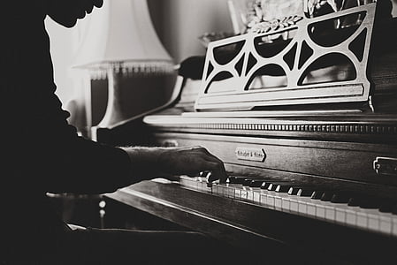 grayscale photography of man playing piano thumbnail