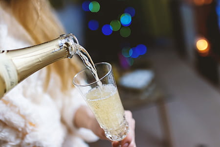 Young girl pours champagne into a glass thumbnail