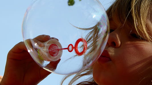 girl making bubble during daytime thumbnail