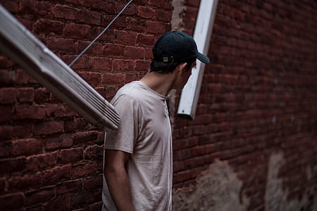 man leaning on wall thumbnail