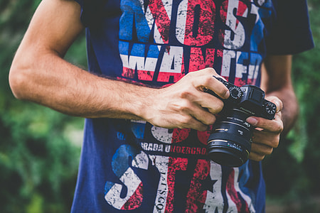 person holding black DSLR camera thumbnail