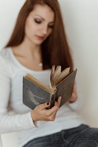 Beautiful young woman reading a book thumbnail
