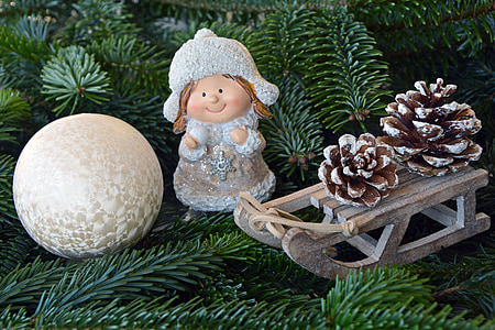 girl standing beside sleigh figurine thumbnail