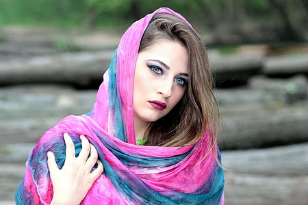 selective focus photography of woman wearing blue and pink shawl thumbnail