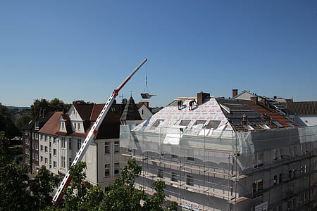 white lift crane near building during daytime thumbnail