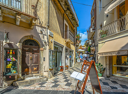 brown wooden easel board in the middle on the street under blue sky thumbnail