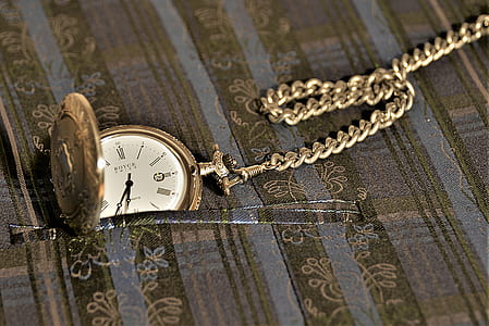 silver-colored pocket watch on floral textile thumbnail