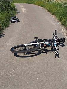 white bike on gray road thumbnail