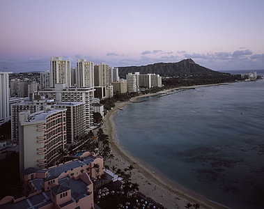 view of city buildings near body of water thumbnail