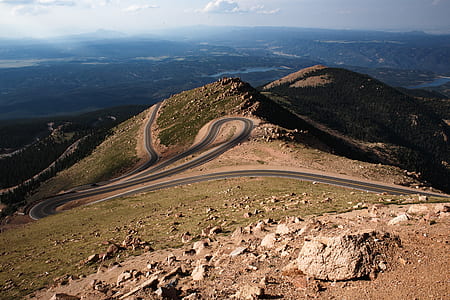 gray asphalt road on mountain during daytime thumbnail