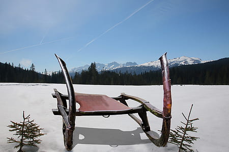 brown wooden sled on snow field thumbnail