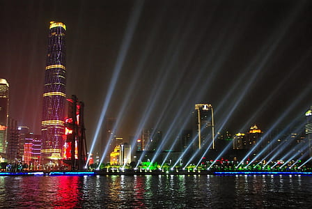 lighted building near body of water thumbnail