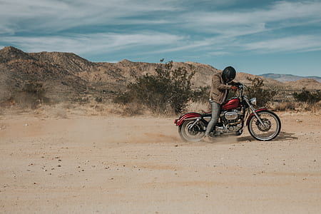 man riding motorcycle surrounded by mountain thumbnail