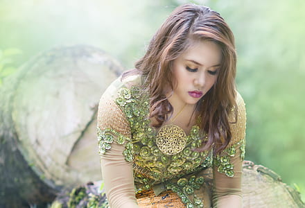 woman sitting on tree trunk thumbnail