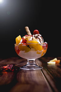 closeup photo of cup of ice cream on wooden surface thumbnail