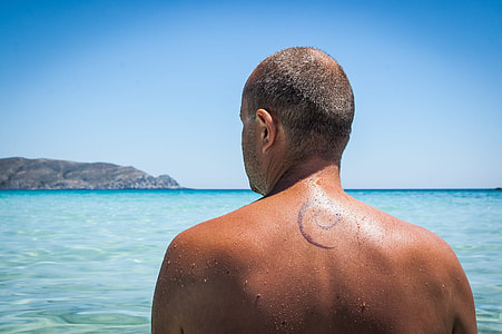 man soaking on body of water thumbnail