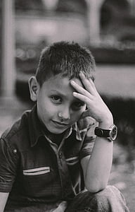 boy in collared shirt resting his head on his hand thumbnail