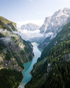 aerial view of river surrounded by mountains thumbnail