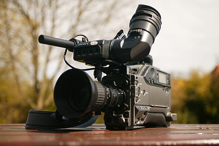 Black Video Camera on Brown Wooden Table thumbnail