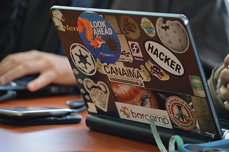 assorted stickers on black laptop computer thumbnail