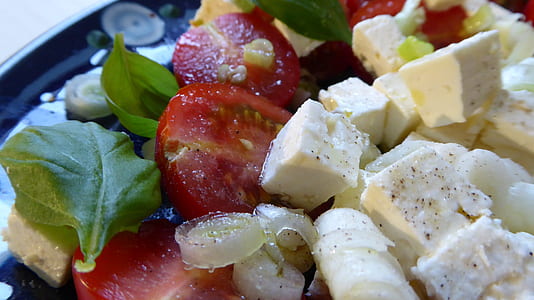 close-up photo of sliced tomato and vegetable leaf thumbnail