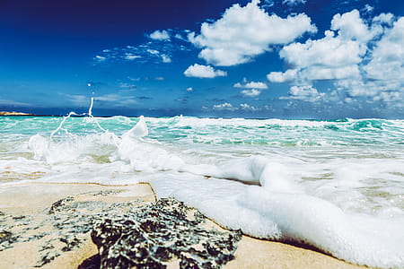 Landscape Photography of Beach With Raging Waves Under Clear Skies thumbnail