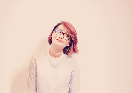 woman in white crew-neck sweater and black framed eyeglasses thumbnail