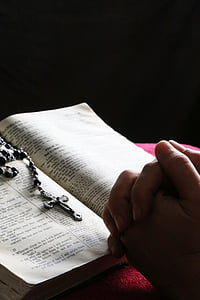 person praying in front of the rosary and bible thumbnail
