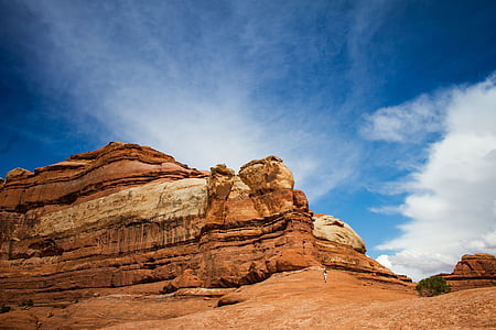 brown cliff under cloudy sky thumbnail