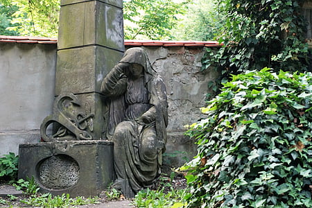 female concrete statue beside fence thumbnail