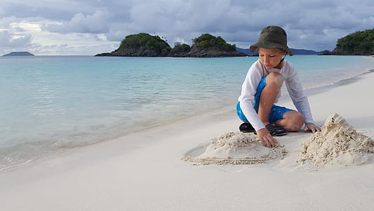 girl playing sand in beach thumbnail