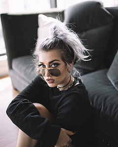 woman sitting beside bed thumbnail