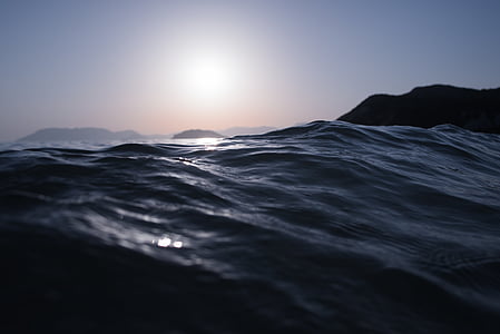 clear body of water and silhouette of mountain thumbnail
