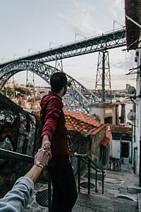 man wearing red dress shirt walking near the building thumbnail