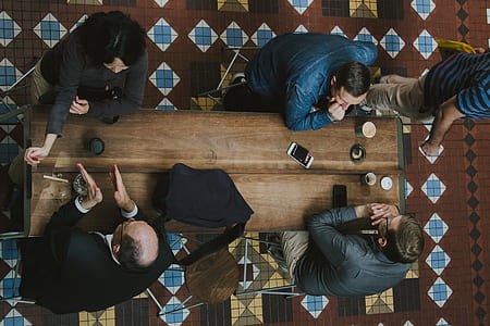 four person sitting on chair inside room thumbnail