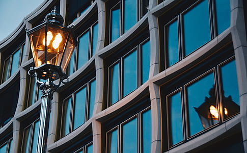 black outdoor lantern beside curtain glass wall building thumbnail