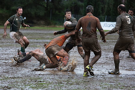 rugby playing on wet field during daytime thumbnail