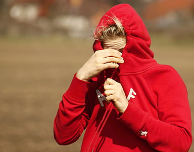 tilt shift focus photography of man in red pullover thumbnail