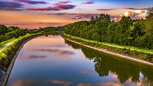 river in between green forest painting thumbnail