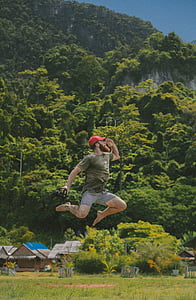 man jumping high holding camera thumbnail