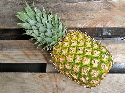 green pineapple on brown wooden pallet board thumbnail